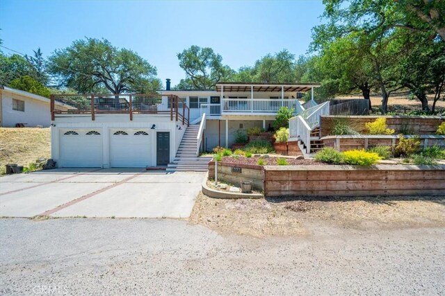 7560 Castano Ave, Atascadero, CA 93422 - view of front of property with stairs, concrete driveway, a garage, and covered porch