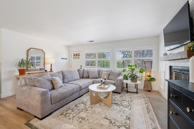 7560 Castano Ave, Atascadero, CA 93422 - living area featuring light wood finished floors and a fireplace