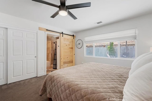 7560 Castano Ave, Atascadero, CA 93422 - carpeted bedroom with a barn door, connected bathroom, ceiling fan, and a closet