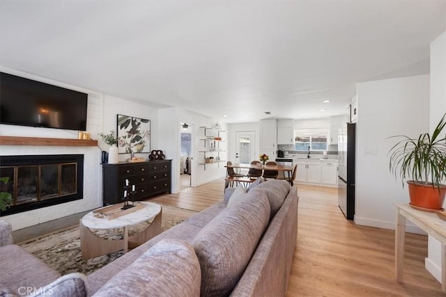 7560 Castano Ave, Atascadero, CA 93422 - living room featuring a glass covered fireplace and light wood-type flooring
