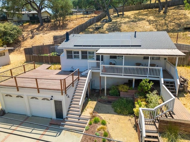 7560 Castano Ave, Atascadero, CA 93422 - view of front of property featuring stairway, a wooden deck, solar panels, driveway, and a shingled roof