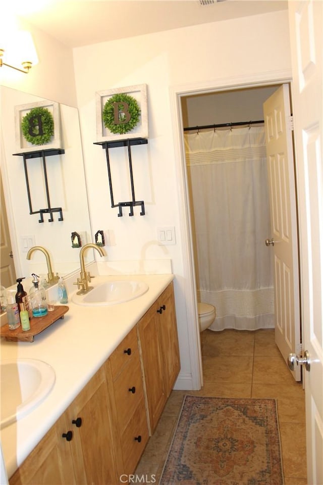 45344 Saint Tisbury St, Temecula, CA 92592 - bathroom with toilet, double vanity, tile patterned floors, and curtained shower