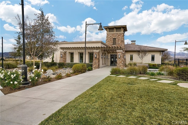 1583 Turtle Crk, Beaumont, CA 92223 - view of front of house with stucco siding, a pergola, stone siding, and a chimney