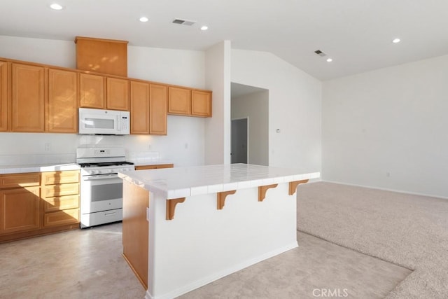 1583 Turtle Crk, Beaumont, CA 92223 - kitchen featuring white appliances, tile countertops, vaulted ceiling, a center island, and recessed lighting