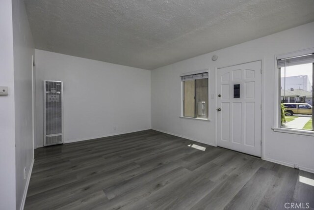2292 Euclid Ave, Long Beach, CA 90815 - foyer entrance featuring a heating unit, wood finished floors, a textured ceiling, and baseboards