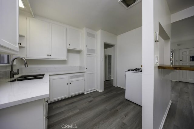 2292 Euclid Ave, Long Beach, CA 90815 - kitchen featuring a sink, dark wood-type flooring, white cabinets, light stone counters, and baseboards