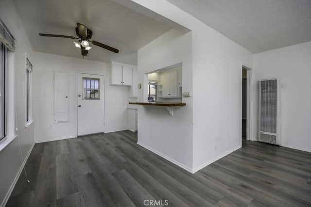 2292 Euclid Ave, Long Beach, CA 90815 - unfurnished living room with a heating unit, ceiling fan, dark wood-style floors, and baseboards