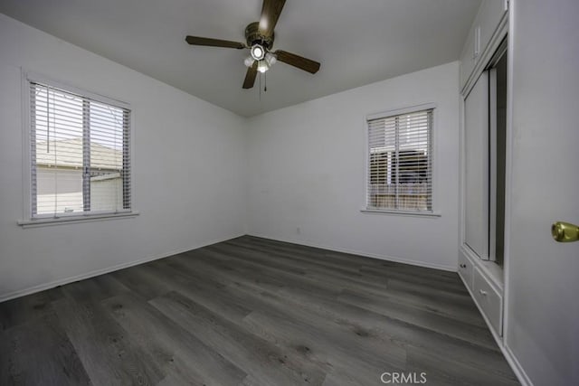 2292 Euclid Ave, Long Beach, CA 90815 - unfurnished bedroom with multiple windows, dark wood-style floors, baseboards, and a closet