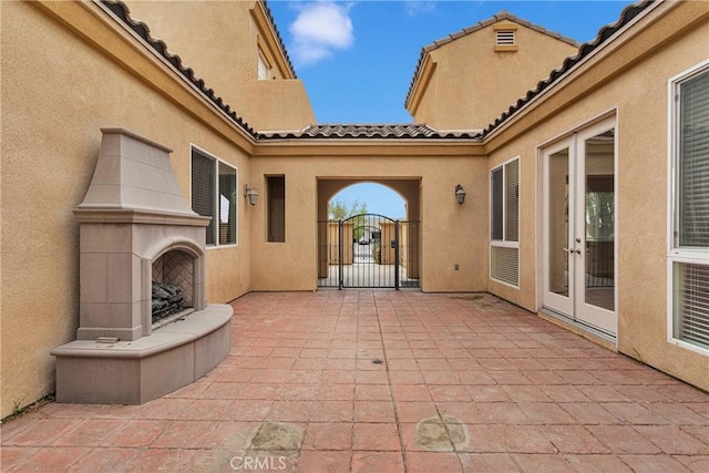 17830 Mana Rd, Apple Valley, CA 92307 - view of patio / terrace with a fireplace, a gate, and french doors