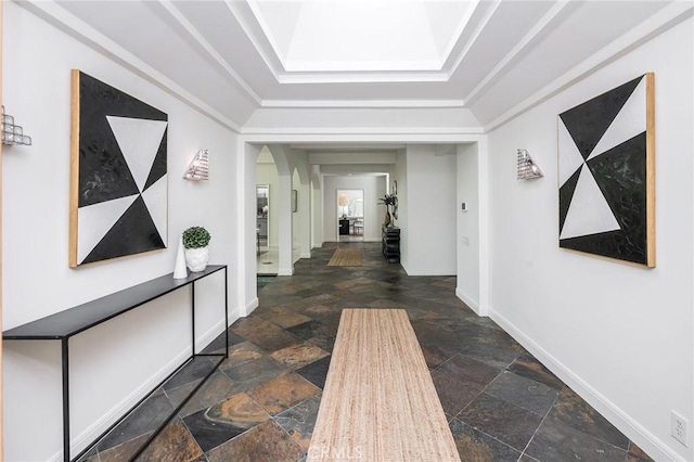 4820 Encino Ter, Encino, CA 91316 - hallway featuring stone tile floors, baseboards, arched walkways, and a tray ceiling