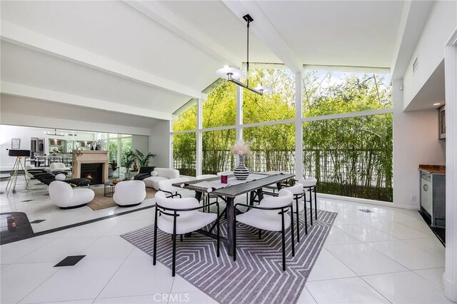 4820 Encino Ter, Encino, CA 91316 - dining room featuring light tile patterned flooring and a warm lit fireplace