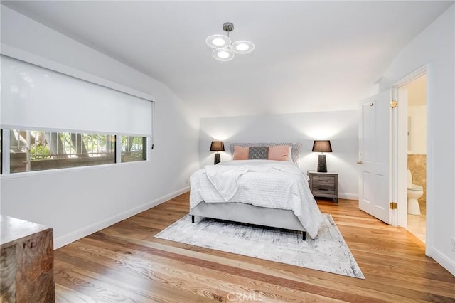 4820 Encino Ter, Encino, CA 91316 - bedroom with vaulted ceiling, baseboards, light wood-style floors, and ensuite bath