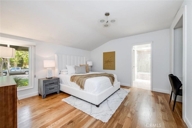 4820 Encino Ter, Encino, CA 91316 - bedroom featuring lofted ceiling, light wood-type flooring, baseboards, and ensuite bath