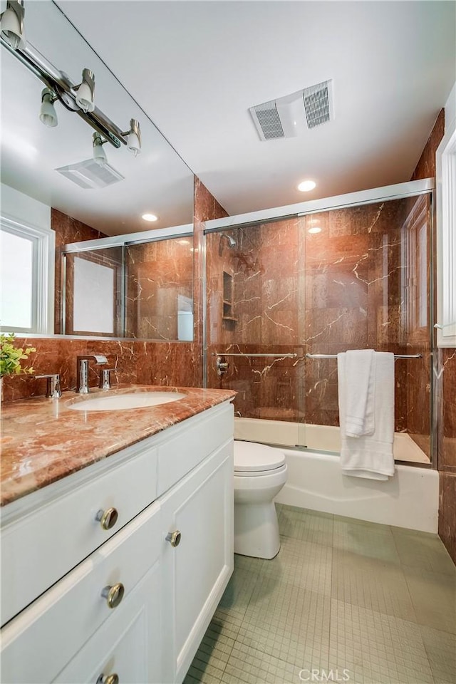 4820 Encino Ter, Encino, CA 91316 - full bath featuring toilet, vanity, shower / bath combination with glass door, tile patterned flooring, and tile walls