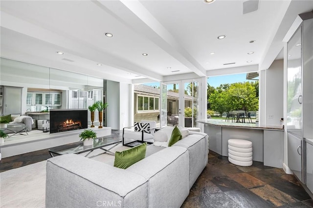 4820 Encino Ter, Encino, CA 91316 - living area with plenty of natural light, stone tile flooring, a lit fireplace, recessed lighting, and french doors