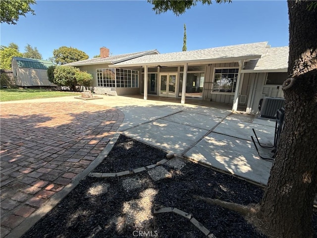 149 Acacia Ave, Oroville, CA 95966 - back of house with a chimney, a patio, french doors, and central AC unit