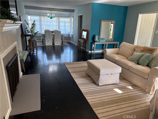 149 Acacia Ave, Oroville, CA 95966 - living area with a chandelier, a fireplace, wood finished floors, and baseboards