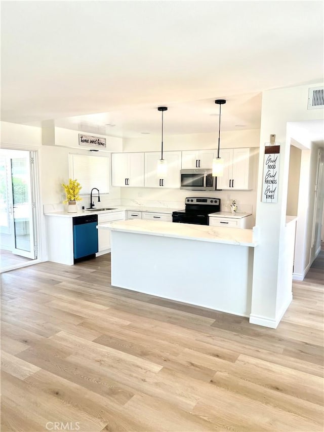 29041 Desert Hills Rd, Menifee, CA 92586 - kitchen with stainless steel microwave, range with electric stovetop, dishwashing machine, and white cabinetry