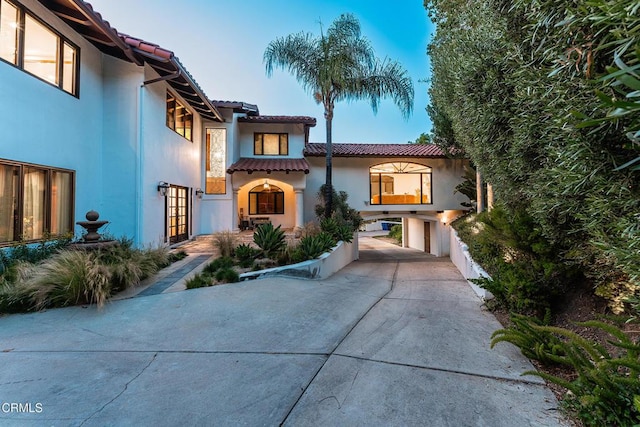 4548 Valley Spring Dr, Westlake Village, CA 91362 - mediterranean / spanish home with a tiled roof, concrete driveway, french doors, and stucco siding