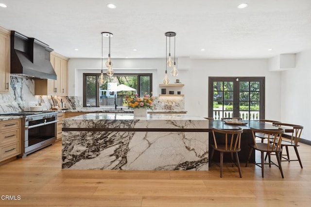 4548 Valley Spring Dr, Westlake Village, CA 91362 - kitchen featuring range with two ovens, custom range hood, a large island, plenty of natural light, and recessed lighting