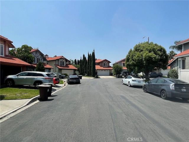 1186 Runaway Cir, Colton, CA 92324 - view of asphalt road featuring a residential view, street lighting, and curbs