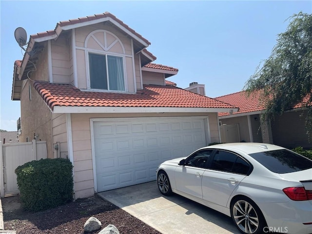 1186 Runaway Cir, Colton, CA 92324 - view of front of home with a tile roof, concrete driveway, and an attached garage