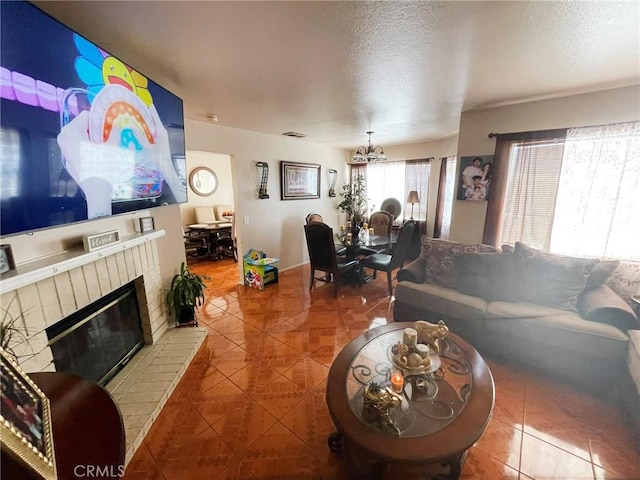 1186 Runaway Cir, Colton, CA 92324 - living area with tile patterned flooring, a chandelier, a brick fireplace, and a textured ceiling
