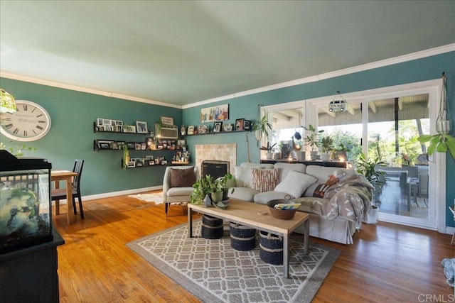 646 Downer Ave, El Cajon, CA 92020 - living area with crown molding, a fireplace, and wood finished floors