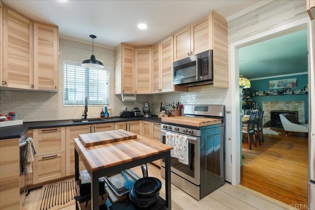 646 Downer Ave, El Cajon, CA 92020 - kitchen featuring stainless steel appliances, light brown cabinets, dark countertops, and ornamental molding