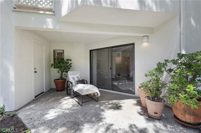 190 N Singingwood St Unit 1, Orange, CA 92869 - doorway to property featuring a patio area and stucco siding