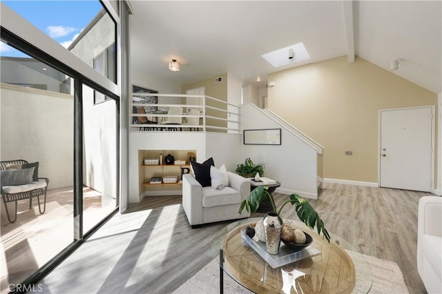 190 N Singingwood St Unit 1, Orange, CA 92869 - living room featuring a skylight, wood finished floors, beam ceiling, high vaulted ceiling, and stairway