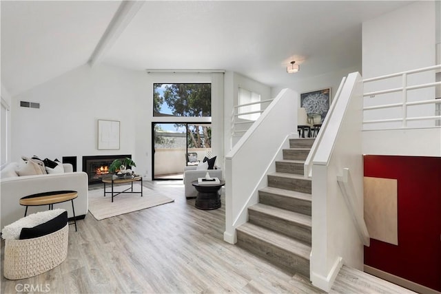 190 N Singingwood St Unit 1, Orange, CA 92869 - stairs featuring wood finished floors and a warm lit fireplace