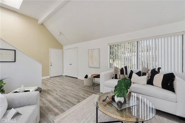 190 N Singingwood St Unit 1, Orange, CA 92869 - living room featuring beamed ceiling, wood finished floors, a skylight, and high vaulted ceiling