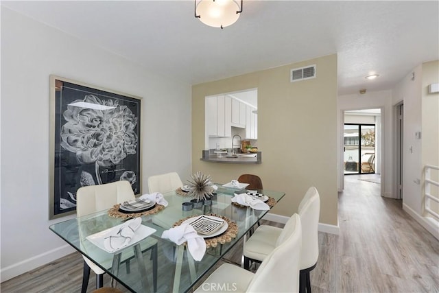 190 N Singingwood St Unit 1, Orange, CA 92869 - dining area with light wood-type flooring and baseboards