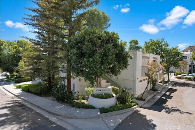 190 N Singingwood St Unit 1, Orange, CA 92869 - view of property exterior featuring a garage and stucco siding