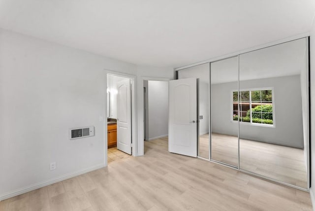 12590 Carmel Creek Rd Unit 1, San Diego, CA 92130 - unfurnished bedroom with light wood finished floors, a closet, baseboards, and ensuite bathroom