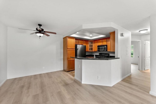 12590 Carmel Creek Rd Unit 1, San Diego, CA 92130 - kitchen with stainless steel appliances, light wood finished floors, brown cabinetry, glass insert cabinets, and dark countertops