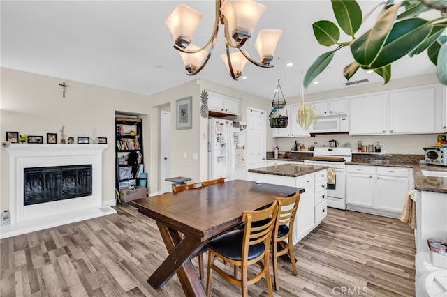 5 Quartz Ln, Ladera Ranch, CA 92694 - kitchen featuring white appliances, a center island, light wood-style floors, white cabinets, and recessed lighting