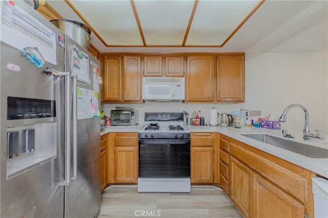 22224 S Vermont Ave Unit 102C, Torrance, CA 90502 - kitchen with white microwave, stainless steel fridge, gas range, and light countertops