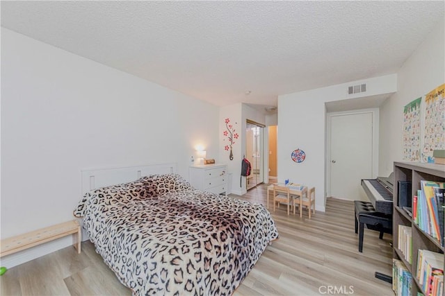 22224 S Vermont Ave Unit 102C, Torrance, CA 90502 - bedroom featuring light wood finished floors and a textured ceiling