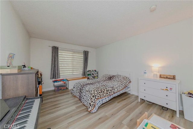 22224 S Vermont Ave Unit 102C, Torrance, CA 90502 - bedroom with wood finished floors and a textured ceiling