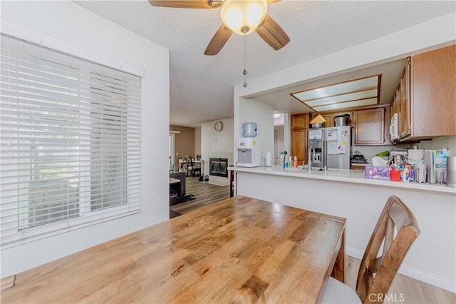 22224 S Vermont Ave Unit 102C, Torrance, CA 90502 - dining area with ceiling fan, light wood finished floors, and a textured ceiling