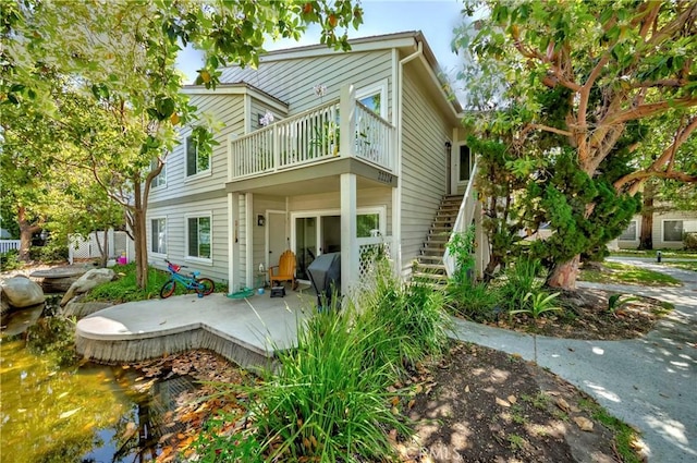 22224 S Vermont Ave Unit 102C, Torrance, CA 90502 - back of house with a balcony and stairs