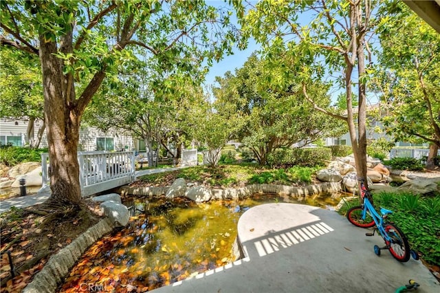 22224 S Vermont Ave Unit 102C, Torrance, CA 90502 - view of home's community with a patio area and a garden pond