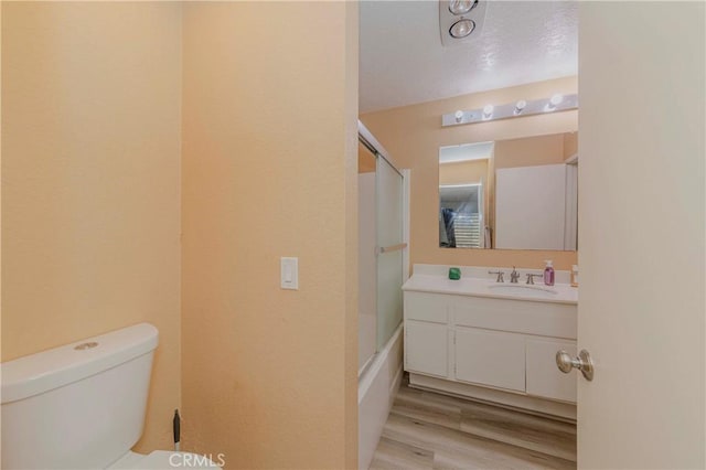 22224 S Vermont Ave Unit 102C, Torrance, CA 90502 - full bathroom featuring vanity, wood finished floors, and enclosed tub / shower combo