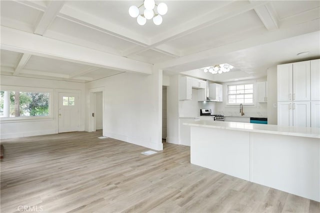 4415 12th St, Riverside, CA 92501 - kitchen featuring a chandelier, stainless steel gas range, coffered ceiling, a sink, and light countertops