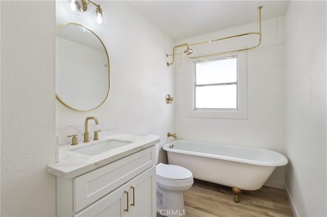 4415 12th St, Riverside, CA 92501 - bathroom with wood finished floors, vanity, toilet, and a combined bath / shower with freestanding tub