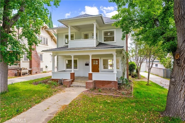 4415 12th St, Riverside, CA 92501 - view of front facade featuring covered porch, a front lawn, and a shingled roof