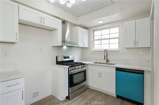 4415 12th St, Riverside, CA 92501 - kitchen with dishwasher, a sink, stainless steel range with gas cooktop, wall chimney exhaust hood, and white cabinets