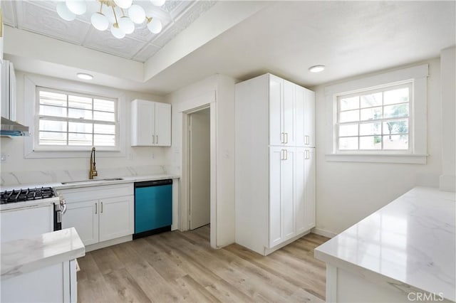 4415 12th St, Riverside, CA 92501 - kitchen featuring dishwashing machine, a sink, light stone countertops, a chandelier, and light wood finished floors